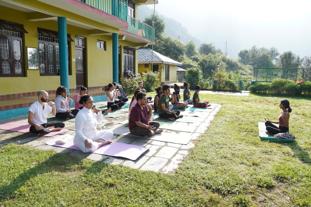 A group practicing yoga outdoors in a tranquil garden, promoting mindfulness and relaxation.